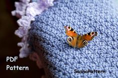 a small butterfly sitting on top of a blue blanket