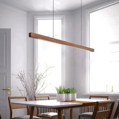 a dining room table with four chairs and a potted plant in the center, hanging over it