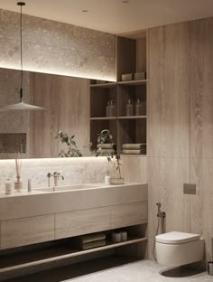 a bathroom with a toilet, sink and shelving unit in the middle of it