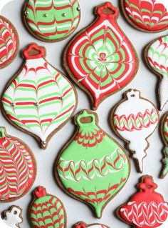 some cookies that are decorated with icing and red, green and white designs on them