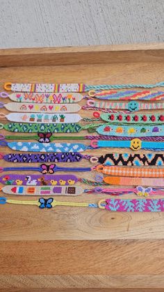 a wooden table topped with lots of bracelets