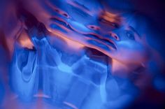 a blurry image of a woman's face in blue light