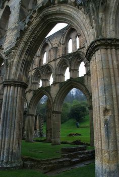 the interior of an old cathedral with stone columns