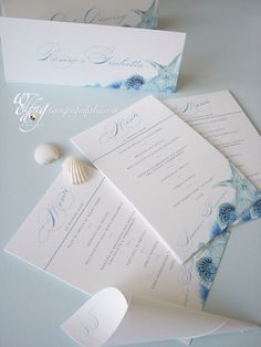 the wedding stationery is laid out on top of each other