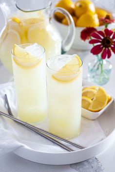 two glasses of lemonade on a white plate