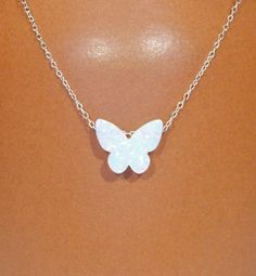 "Opal butterfly necklace, fairytale necklace, fire opal pendant, gift for her, a dainty butterfly on sterling silver or 14k gold filled chain A stunning, one of a kind, opal butterfly hanging happily from a sterling silver or 14k gold filled chain in the length of your choice! The butterflies are available in white and blue and measure 10mm x 12mm. More from BubuRuby? https://www.etsy.com/shop/BubuRuby?ref=hdr_shop_menu Looking for other charm necklaces? https://www.etsy.com/shop/BubuRuby?sectio White Sterling Silver Butterfly Pendant Necklace, Sterling Silver White Butterfly Pendant Necklace, White Sterling Silver Butterfly Necklace, White Butterfly Necklace With Delicate Chain, Delicate White Butterfly Charm Necklace, White Dainty Butterfly Necklace With Delicate Chain, Dainty White Butterfly Pendant Necklace, Dainty White Butterfly Necklace As A Gift, Dainty White Butterfly Necklace Perfect As A Gift