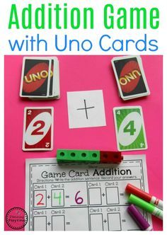 an addition game with uno cards and crayons on a pink background, with the words