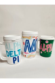 three coffee cups with different designs on them