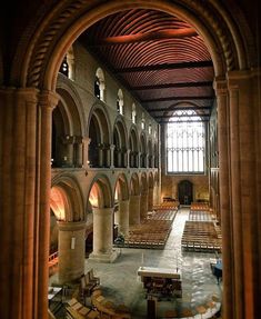 the inside of an old church with pews and stained glass windows