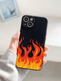 a person holding an iphone case with flames on it