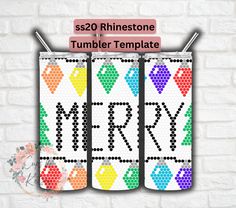 three colorful christmas stockings hanging on a brick wall with the word merry written in black and white