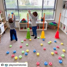 two children playing with toys in a playroom