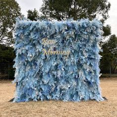 a blue and white sign that says rose morning in gold lettering on the side of it