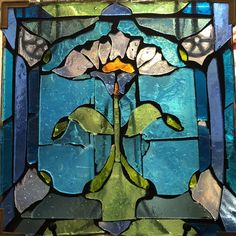 a stained glass window with flowers on it