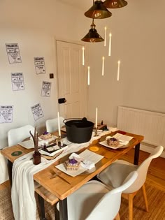 a dining room table with plates and bowls on it