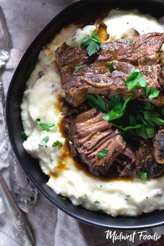 slow cooker braised short ribs with mashed potatoes and parsley on top