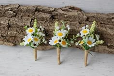 three small wooden sticks with flowers on them