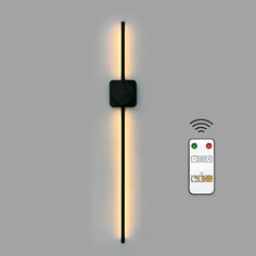 a remote control is shown next to a wall light with an appliance on it