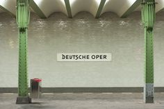 an empty subway station with the sign deutsch open