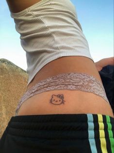 a person with a hello kitty tattoo on their leg