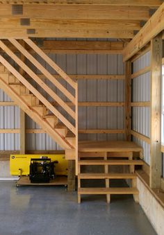 the inside of a building with wooden stairs