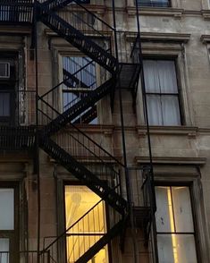 a fire escape is shown on the side of a building with stairs leading up to it