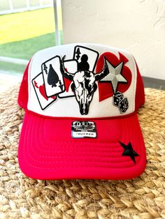 This trendy red and white trucker hat features an eye-catching design with a winning hand of aces, a bold bull skull, and lucky dice, making it the perfect accessory for country lovers, rodeo fans. Red 5-panel Trucker Hat, Novelty Red Trucker Hat, Red Trucker Hat For Rodeo, Red Snapback Trucker Hat For Rodeo, Red Snapback Hat For Rodeo, Western Trucker Hats, Dice Making, Country Couture, Red Trucker Hat