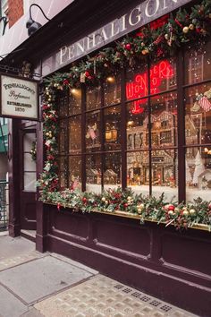 a store front with christmas decorations on the windows