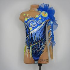 a female mannequin wearing a blue and yellow leotard with an artistic design on it