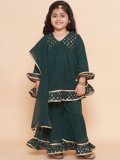 Light, breathable and beautiful sharara set shall definitely be her go-to ethnic pick for any festive occasion. The flared sharara and Kurta are made in cotton, adorned with ornamental laces. The relaxed silhouette and natural material ensure the utmost comfort for the little one, so the best smile is always on. Care Instructions: Hand Wash Only Fit Type: Regular Sale Package: 1 Kurta, 1 Sharara Fabric Details :-  Kurta - Georgette, Sharara - Georgette Kurta Features - Floral Pattern, Full Sleev Festive Sharara With Dabka For Diwali, Festive Bollywood Sharara With Gota Work, Festive Sharara With Straight Kurta And Dabka Detailing, Dabka Sharara With Straight Kurta For Festive Occasions, Festive Dabka Sharara With Straight Kurta, Bollywood Style Sharara With Gota Work For Festive Occasions, Festive Sharara With Dabka For Navratri, Bollywood Style Festive Sharara With Gota Work, Bollywood Gota Work Palazzo Set For Diwali