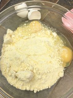 eggs and flour in a glass bowl on a counter