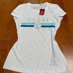 Guess Logo Tee Shirts Is Brand New With The Tags Size : S Color : White Made In Bangladesh Fitted Logo Top With Short Sleeves, Fitted Short Sleeve Tops With Logo, Trendy White Top With Logo, Casual Short Sleeve Shirt With Logo, Logo Fitted Crew Neck Top, Casual Short Sleeve Logo Top, Fitted Sporty Tops With Logo, Sporty Fitted Tops With Logo, White Fitted Logo Top