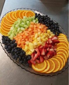 a platter filled with sliced fruit on top of a counter