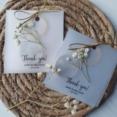 two thank you cards on a wicker basket with twine and baby's breath flowers