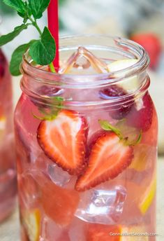 a mason jar filled with lemonade and strawberries