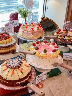 several cakes are on display at a bakery