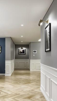 an empty room with wood floors and blue walls