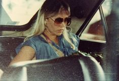 a woman sitting in the passenger seat of a car