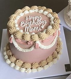 a pink and white birthday cake with the words happy birthday mam written on it