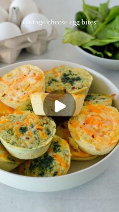 a bowl filled with egg cups and spinach