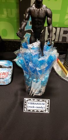 a table topped with a plastic gorilla figure next to a can of gummy bears