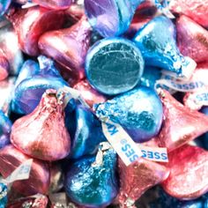 a pile of heart shaped candies sitting on top of each other in blue and pink