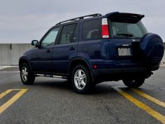 a blue suv parked in a parking lot