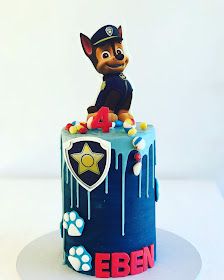 a birthday cake decorated to look like a police dog on top of a fire hydrant