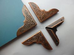 three pieces of metal with designs on them