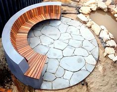 a wooden bench sitting on top of a stone slab