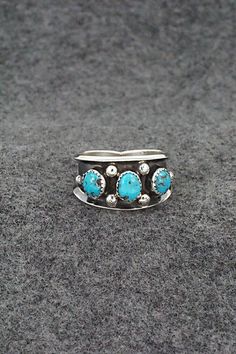 This turquoise and sterling silver ring was made by Navajo silversmith Paul Largo. The inside is stamped sterling.Size: 10Length: 1/2"Free shipping on all orders! We ship with USPS and always include tracking. All orders ship within a day of payment.Returns are accepted up to 30 days after you receive your order. Just send us a message. Our shop offers cash back or store credit. The item must be returned in new condition. Southwestern Sterling Silver Turquoise Ring For Anniversary, Western Style Untreated Sterling Silver Rings, Western Style Blue Sterling Silver Ring, Southwestern Turquoise Open Ring In Sterling Silver, Southwestern Style Turquoise Open Ring In Sterling Silver, Southwestern Sterling Silver Turquoise Open Ring, Southwestern Untreated Turquoise Sterling Silver Ring, Untreated Southwestern Turquoise Sterling Silver Ring, Navajo Rings