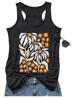 a women's tank top with an orange and white flower design on the front