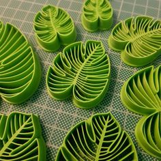 several green leaf shaped objects on a table