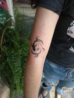 a woman's arm with a tattoo on it and a fish in the middle